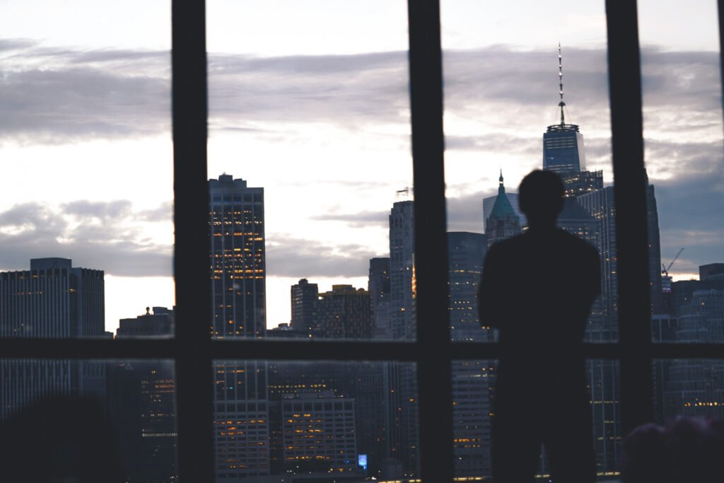 businessman looking forward city skyline dark blue