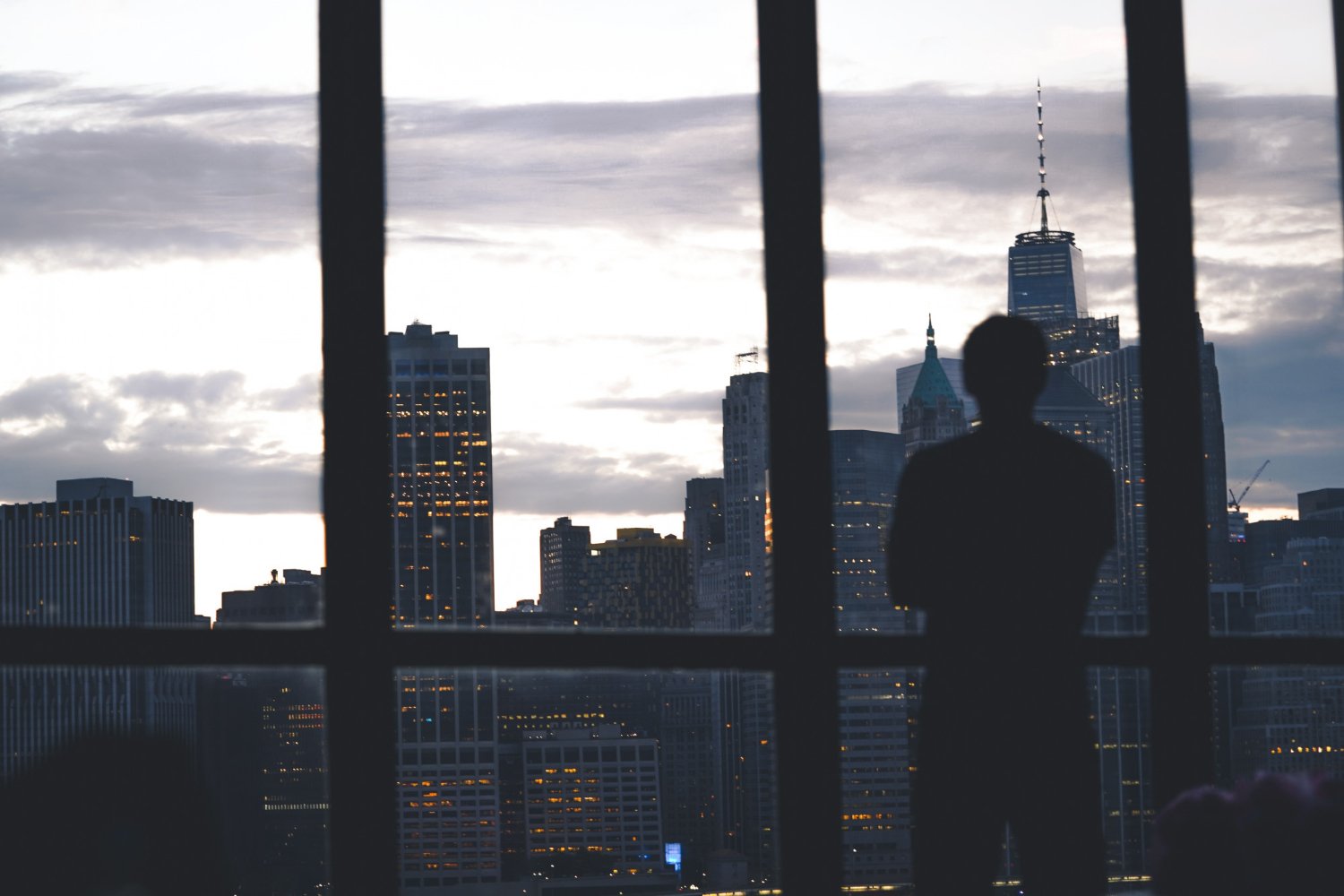 businessman looking forward city skyline dark blue